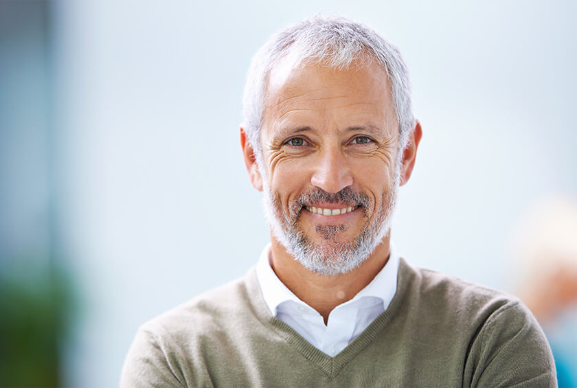 older man smiling.