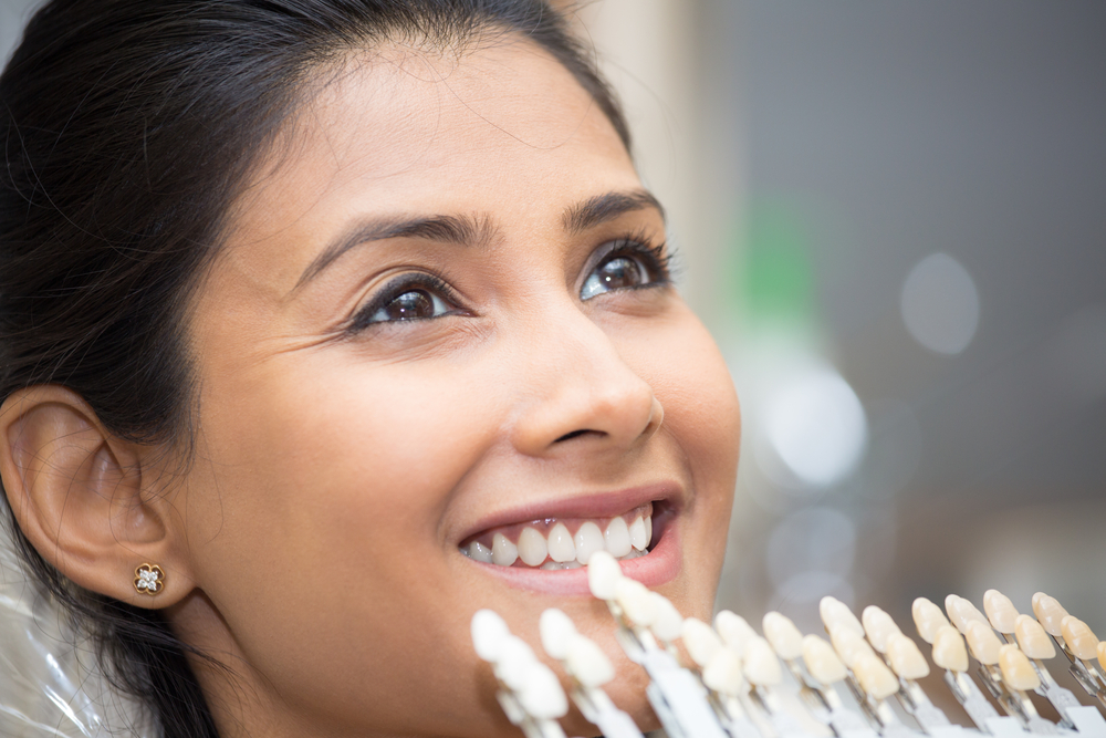 woman receiving porcelain veneers -- cosmetic dentist in Dearborn, MI