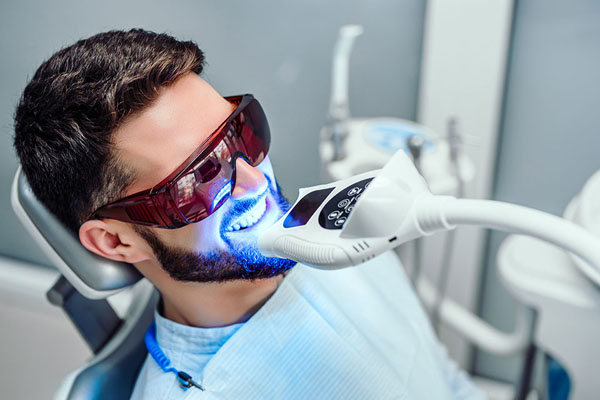 patient getting professional teeth whitening treatment